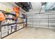 Spacious garage with overhead storage containers, shelving, and sealed concrete flooring at 4427 Bright Rd, Charlotte, NC 28214