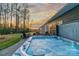 Backyard featuring a luxurious hot tub with patio and lush landscaping, perfect for relaxation at 4427 Bright Rd, Charlotte, NC 28214
