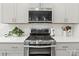 Stainless steel stove and range with a white tile backsplash compliment the white countertops and cabinets at 4427 Bright Rd, Charlotte, NC 28214