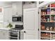 A modern kitchen featuring stainless steel appliances, gray cabinets, and a pantry, offering ample storage and style at 4427 Bright Rd, Charlotte, NC 28214