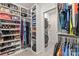 Custom walk-in closet includes built-in shelving, hanging racks and leads to a laundry room with modern washer and dryer at 4427 Bright Rd, Charlotte, NC 28214