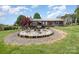 Inviting backyard with stone patio, wooden fence and cozy seating area, perfect for outdoor entertaining and relaxation at 4478 Fork Rd, Norwood, NC 28128