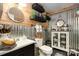 Stylish bathroom with a modern vanity, decorative shelves, and unique metal wall accents, offering a chic experience at 4478 Fork Rd, Norwood, NC 28128