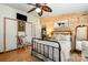 Well-lit bedroom boasts wood accent wall, large closets, and neutral decor at 4478 Fork Rd, Norwood, NC 28128
