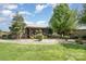Charming log cabin home with a metal roof, mature trees, and lush green lawn at 4478 Fork Rd, Norwood, NC 28128