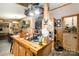 Farmhouse-style kitchen with a butcher block island, cooktop, and wooden cabinets, creating a rustic culinary space at 4478 Fork Rd, Norwood, NC 28128
