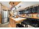 Cozy kitchen features a wood island, black cabinets, wooden countertops, and stainless steel appliances at 4478 Fork Rd, Norwood, NC 28128