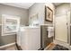 The laundry room offers convenience, a glass door shower, and a window for natural light at 4478 Fork Rd, Norwood, NC 28128