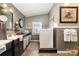 Functional laundry room with a sink, ample storage, and modern appliances, providing convenience and efficiency at 4478 Fork Rd, Norwood, NC 28128