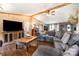 Comfortable living area with hardwood floors, exposed beams, and a large sectional sofa at 4478 Fork Rd, Norwood, NC 28128