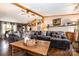 Inviting living room features a large sofa, wood accents, and a decorative coffee table, creating a warm atmosphere at 4478 Fork Rd, Norwood, NC 28128