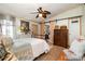 Charming main bedroom featuring a wood accent wall, barn door to bathroom, and ample natural light from the window at 4478 Fork Rd, Norwood, NC 28128