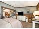 Spacious bedroom featuring wood accents, a TV, and a comfortable sitting area, providing a relaxing environment at 4478 Fork Rd, Norwood, NC 28128