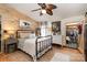 Comfortable bedroom with wood accent wall, iron bed frame, closet, and neutral decor at 4478 Fork Rd, Norwood, NC 28128