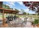Backyard featuring an outdoor kitchen area with built-in grill and covered dining space at 4478 Fork Rd, Norwood, NC 28128