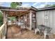 Cozy wooden porch featuring an eating area, string lights, and metal railings at 4478 Fork Rd, Norwood, NC 28128