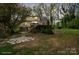 Backyard view featuring a deck, patio, and lush greenery at 469 Augusta Dr, Statesville, NC 28625