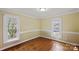 Inviting bedroom with hardwood floors and natural light from two windows with white trim at 469 Augusta Dr, Statesville, NC 28625