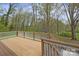 Wooden deck with white railing overlooking a wooded yard at 469 Augusta Dr, Statesville, NC 28625