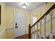 Inviting foyer with white trim and staircase, showcasing classic design elements and warm lighting at 469 Augusta Dr, Statesville, NC 28625
