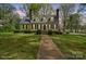 Charming yellow home with blue shutters, brick chimney, and landscaped front yard offers inviting curb appeal at 469 Augusta Dr, Statesville, NC 28625