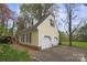 Detached yellow two-car garage with blue shutters and well-maintained landscaping at 469 Augusta Dr, Statesville, NC 28625