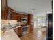 Well-equipped kitchen with stainless steel appliances, wood cabinets, and breakfast nook overlooking the backyard at 469 Augusta Dr, Statesville, NC 28625