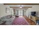 Bright living room with exposed beams, a comfortable sofa, and elegant decor at 469 Augusta Dr, Statesville, NC 28625