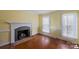 Bright living room featuring a fireplace with classic white molding and hardwood flooring at 469 Augusta Dr, Statesville, NC 28625