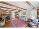 Cozy living room featuring a brick fireplace, exposed beams, and hardwood floors at 469 Augusta Dr, Statesville, NC 28625