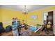 Bright play room featuring hardwood floors, yellow walls, white trim and chandelier lighting at 469 Augusta Dr, Statesville, NC 28625