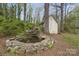 Backyard water feature with stone edging and natural setting at 469 Augusta Dr, Statesville, NC 28625