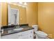 Bathroom featuring granite countertop, white vanity, and toilet at 485 Camrose Ne Cir, Concord, NC 28025