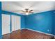 Bright bedroom with wood floors, ceiling fan, and a closet at 485 Camrose Ne Cir, Concord, NC 28025