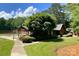 Charming community clubhouse with outdoor seating and lush landscaping near the pool at 485 Camrose Ne Cir, Concord, NC 28025