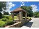 A closer look at the stone-clad entrance pillar with its well-maintained surrounding greenery at 485 Camrose Ne Cir, Concord, NC 28025
