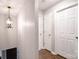 Hallway with light colored walls, wood floors and a decorative light fixture at 485 Camrose Ne Cir, Concord, NC 28025