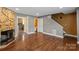Spacious living room with fireplace, hardwood floors, and doorways to kitchen, bath, and staircase at 485 Camrose Ne Cir, Concord, NC 28025