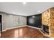 Bright living room with hardwood floors, stone fireplace, and large window at 485 Camrose Ne Cir, Concord, NC 28025