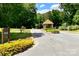 Welcoming Oakleaf neighborhood entrance with manicured landscaping and stone pillar structure at 485 Camrose Ne Cir, Concord, NC 28025