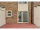 Back patio featuring a sliding glass door and brick exterior at 485 Camrose Ne Cir, Concord, NC 28025