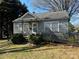 Charming single-story home with a ramp, small porch, and mature trees on a sunny day at 523 29Th Avenue Nw Dr, Hickory, NC 28601