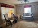 Cozy living room featuring a comfortable sofa, chair, ceiling fan, and vintage decor at 523 29Th Avenue Nw Dr, Hickory, NC 28601