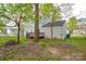 Wide backyard showcasing exterior, trees, and wooden deck at 6020 Running Deer Rd, Charlotte, NC 28214