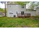 A view of the backyard and the back of the home with a wooden deck at 6020 Running Deer Rd, Charlotte, NC 28214