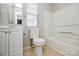 Bathroom with a vanity, toilet, bathtub and a window at 6020 Running Deer Rd, Charlotte, NC 28214