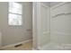 Bright bathroom featuring a step-in shower and natural light from the window at 6020 Running Deer Rd, Charlotte, NC 28214