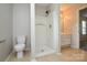 A bathroom featuring a stand up shower, toilet, vanity and a window at 6020 Running Deer Rd, Charlotte, NC 28214