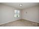 Bedroom with neutral walls, window, and carpet at 6020 Running Deer Rd, Charlotte, NC 28214