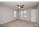 Spacious bedroom featuring neutral walls, carpet flooring, ceiling fan and two windows, creating a comfortable retreat at 6020 Running Deer Rd, Charlotte, NC 28214